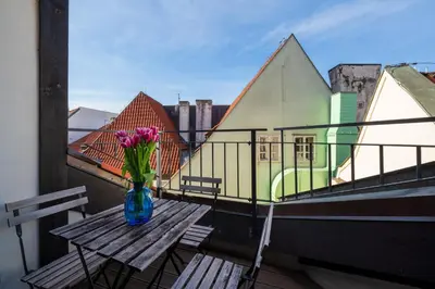 a vase of flowers sitting on a table on a balcony at Old Town Square Premium Residence in Prague