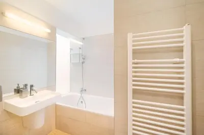 a bathroom with a sink and a tub and a toilet at Old Town Square Premium Residence in Prague