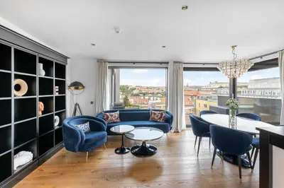 a living room with a blue couch and chairs and a table at Numa Prague Republika in Prague