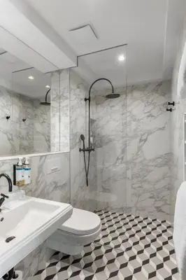 a bathroom with a toilet and a sink and a shower at Numa Prague Republika in Prague