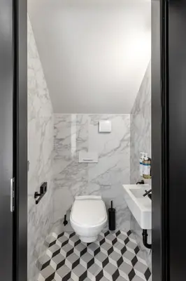 a bathroom with a white toilet and a sink at Numa Prague Republika in Prague