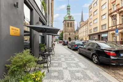 a street with cars parked on the side of the road at Numa Prague Republika in Prague