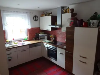 a small kitchen with white cabinets and a window at App Tony Beroun in Beroun