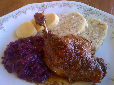 a plate of food with meat and other foods at Penzion V polích in Malé Číčovice