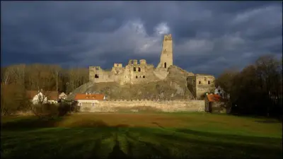 an old castle with a tower on top of it at Penzion V polích in Malé Číčovice