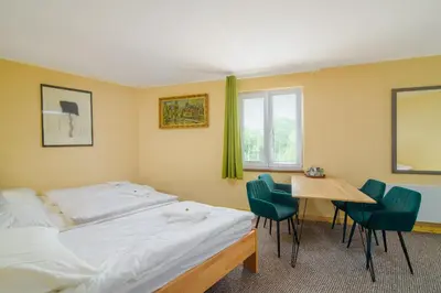 a bedroom with a bed and a table and chairs at Hotel Max in Prague