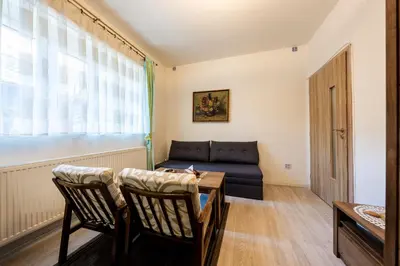 a living room with a couch and a table and chairs at U svaté Ludmily in Litoměřice