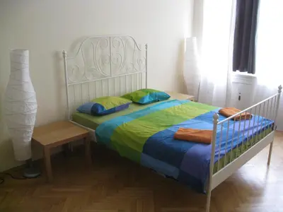 a bedroom with a bed with a blue and green blanket at Ragtime in Prague