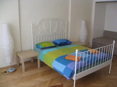 a bedroom with a white bed with a colorful blanket at Ragtime in Prague