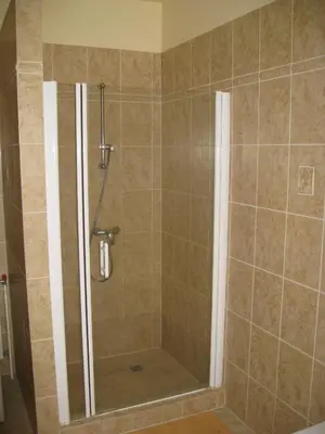 a shower with a glass door in a bathroom at Ragtime in Prague