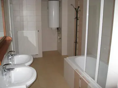 a bathroom with a toilet and a tub and a sink at Ragtime in Prague