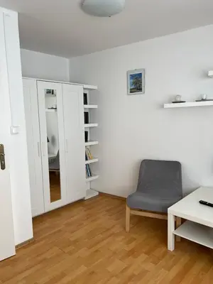 a living room with a chair and a table at Celý dům v historickém centru Loun in Louny