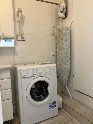 a washer and dryer in a small bathroom at Celý dům v historickém centru Loun in Louny