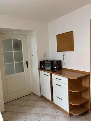 a kitchen with a counter with a microwave and a door at Celý dům v historickém centru Loun in Louny