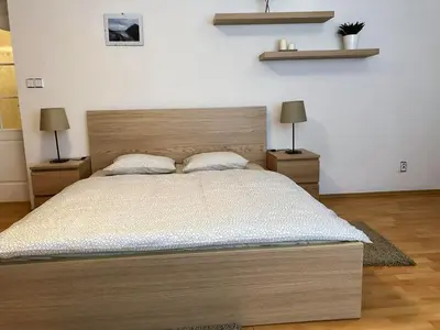 a bedroom with a large bed with two night stands at Celý dům v historickém centru Loun in Louny