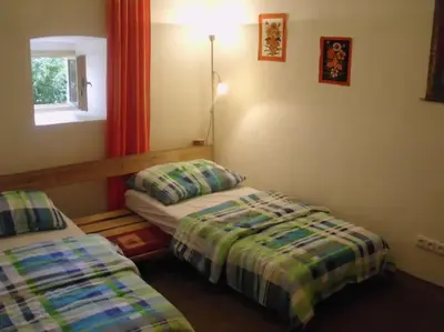 a room with two beds and a window at Bohemia Retreat in Neveklov