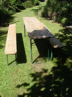a picnic table and a bench in the grass at Bohemia Retreat in Neveklov