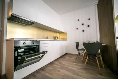 a kitchen with a stove and a table and chairs at Prague friendly apartments in Prague in Prague