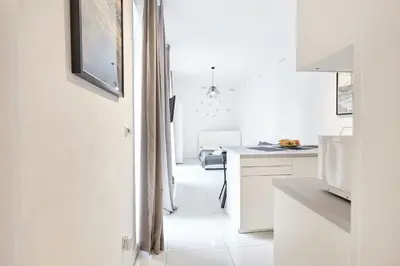 a kitchen with white cabinets and a white floor at Prague friendly apartments in Prague in Prague