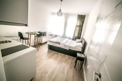 a small bedroom with a bed and a table at Prague friendly apartments in Prague in Prague