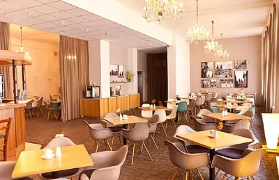 a restaurant with tables and chairs in a room at Central Hotel Prague in Prague