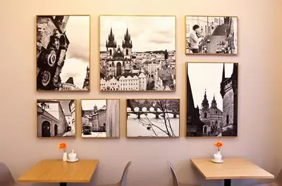 a group of pictures hanging on a wall at Central Hotel Prague in Prague
