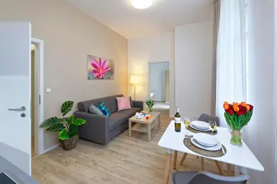 a living room with a couch and a table at DownTown Suites Jugoslavska in Prague