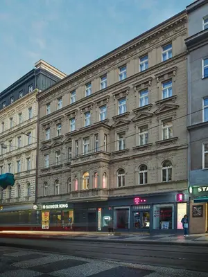 a large building on a street with a street at DownTown Suites Jugoslavska in Prague