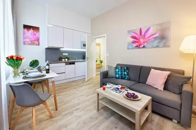 a living room with a couch and a table at DownTown Suites Jugoslavska in Prague