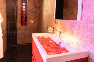 a bathroom with a white sink with fruit on it at Romantický wellness suite hotel Heinz in Dobříš