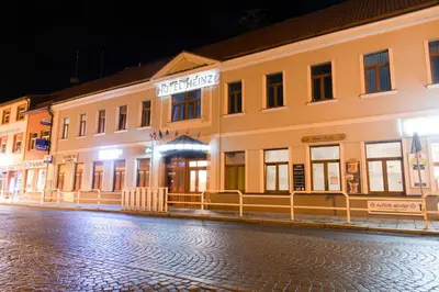 a building on a city street at night at Romantický wellness suite hotel Heinz in Dobříš