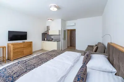a bedroom with a large bed and a couch at Hotel Karlova Prague - Mostecka 10 st Depandance in Prague