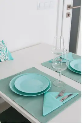 a table with two blue plates and a glass at FREE PARKING IN GARAGE Karolina Plazza, new cosy studio with all you need in Prague