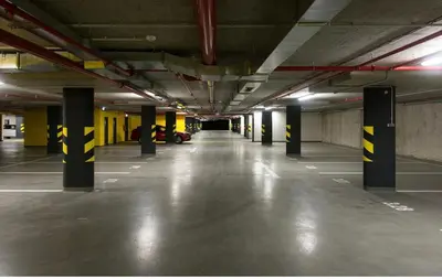 an empty parking garage with yellow and black poles at FREE PARKING IN GARAGE Karolina Plazza, new cosy studio with all you need in Prague