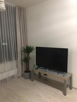 a flat screen tv sitting on a table in a living room at FREE PARKING IN GARAGE Karolina Plazza, new cosy studio with all you need in Prague