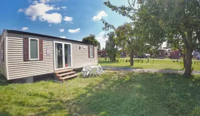 a tiny house in a field with a yard at Triocamp Praha in Prague