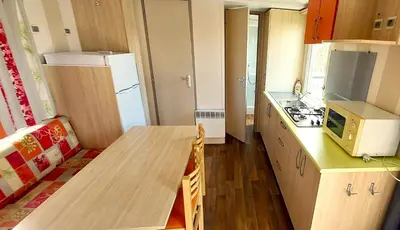 a small kitchen with a table and a refrigerator at Triocamp Praha in Prague