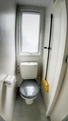 a small bathroom with a toilet and a window at Triocamp Praha in Prague