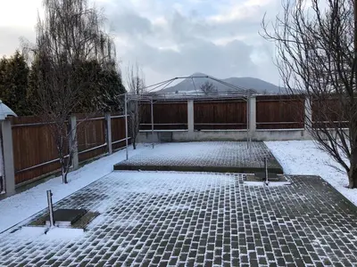 a courtyard covered in snow with a fence at Motel Red Oil in Lovosice