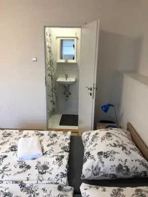 a bedroom with a bed and a sink and a mirror at Motel Red Oil in Lovosice