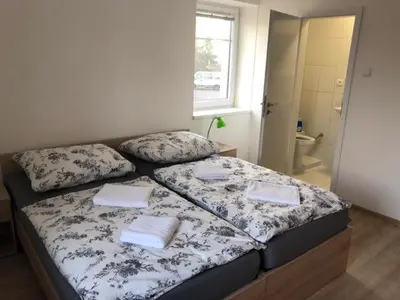 a bed with two pillows on it in a bedroom at Motel Red Oil in Lovosice
