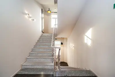 a staircase in a house with white walls at Modern Apt with portable AC and Cozy Terrace in Prague