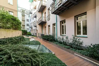 a walkway between two buildings with a glass pond in the middle at Modern Apt with portable AC and Cozy Terrace in Prague