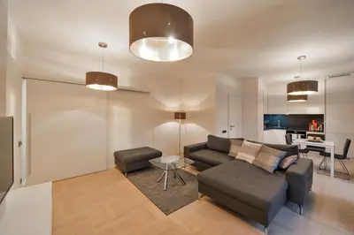 a living room with a couch and a table at Modern Apt with portable AC and Cozy Terrace in Prague