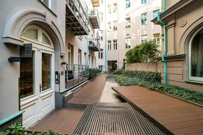 an empty alley in a city with buildings at Modern Apt with portable AC and Cozy Terrace in Prague