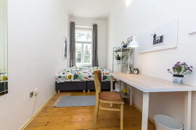 a small room with a desk and a bed at Apartments Grebovka in Prague