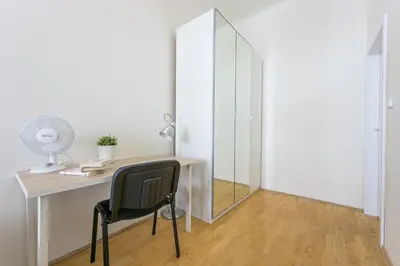a desk with a chair and a mirror in a room at Apartments Grebovka in Prague
