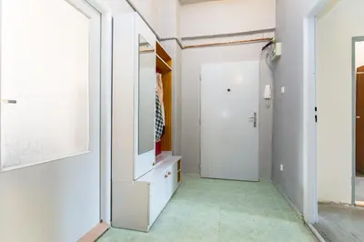 a hallway with white walls and a white door at Apartments Grebovka in Prague