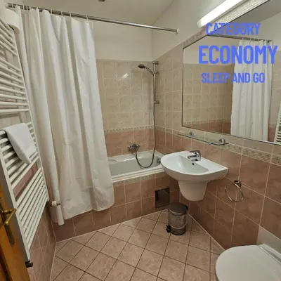 a bathroom with a sink and a shower and a toilet at Hotel Claris in Prague