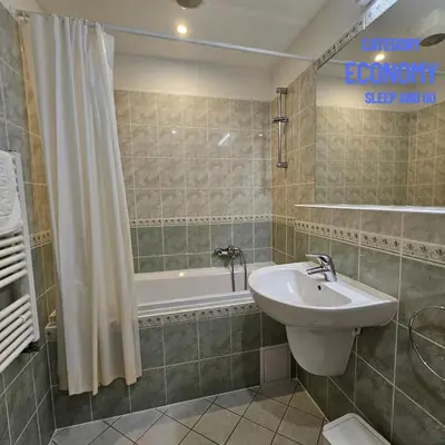a bathroom with a sink and a bath tub at Hotel Claris in Prague